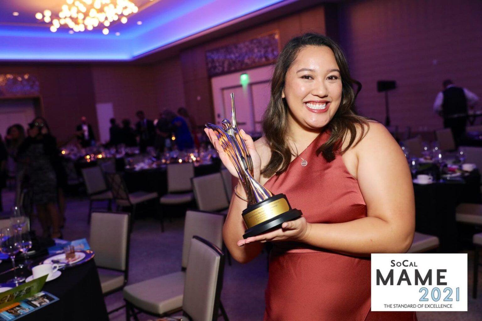 Andrea Villanueva holding a SoCal MAME 2021 award