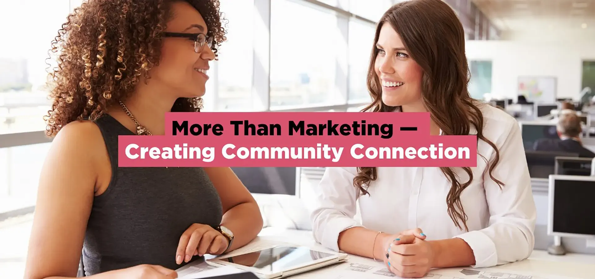 Two professionals meeting in an office to discuss community-focused marketing strategies for homebuilders.
