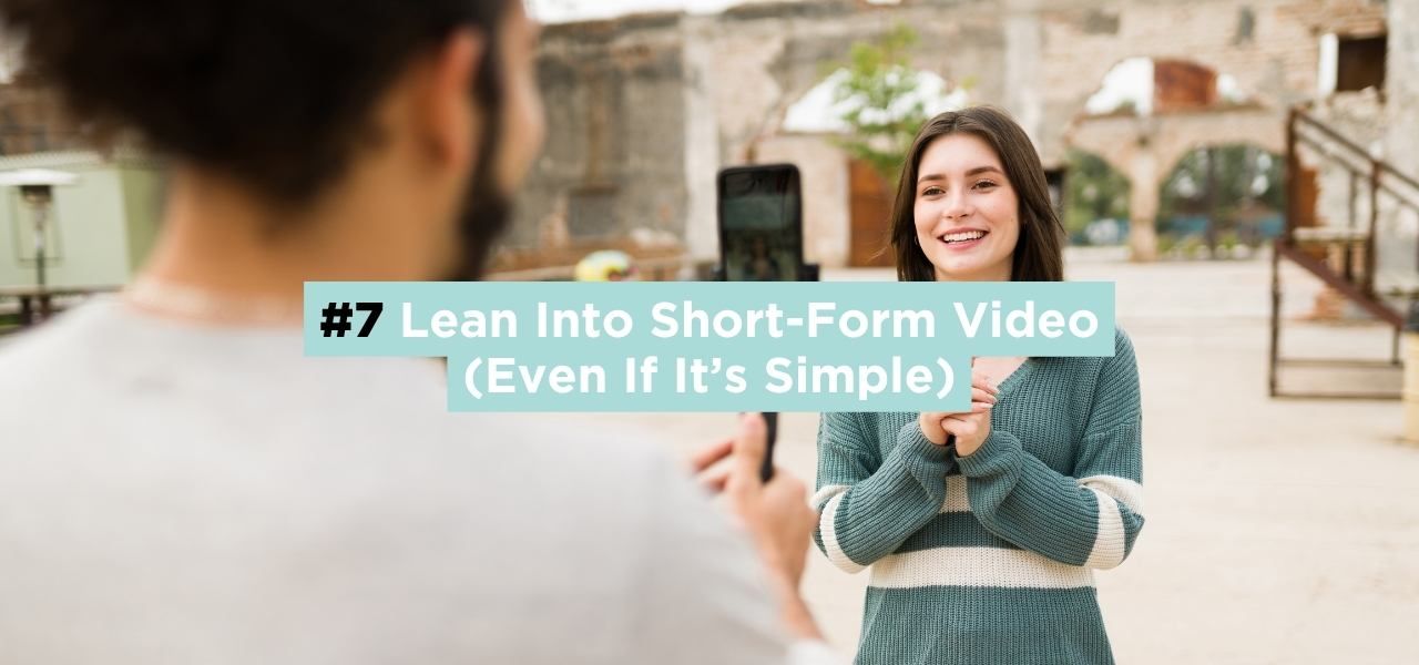 Person filming a video on a smartphone while another person speaks on camera, demonstrating short-form video content creation.
